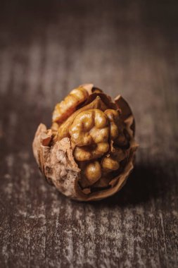 close up view of shelled walnut on wooden tabletop clipart