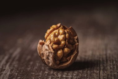 close up view of shelled walnut on wooden tabletop clipart