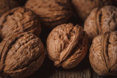 full frame of natural walnuts as backdrop clipart
