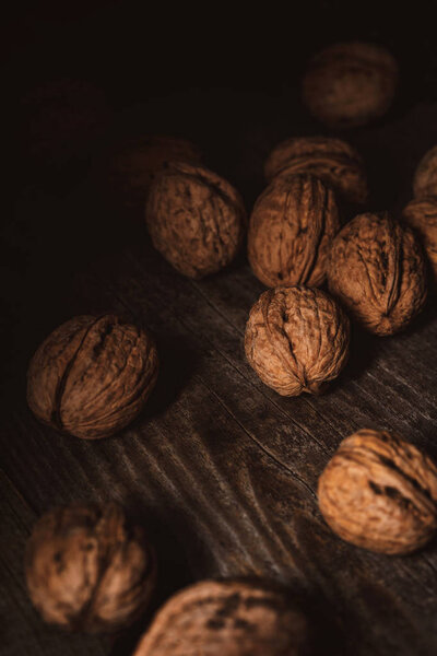 close up view of walnuts in husk on wooden table