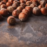 Close up view of shelled hazelnuts on grey tabletop