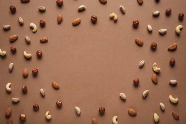 Full Frame Various Nuts Arranged Brown Backdrop Empty Space Middle — Stock Photo, Image