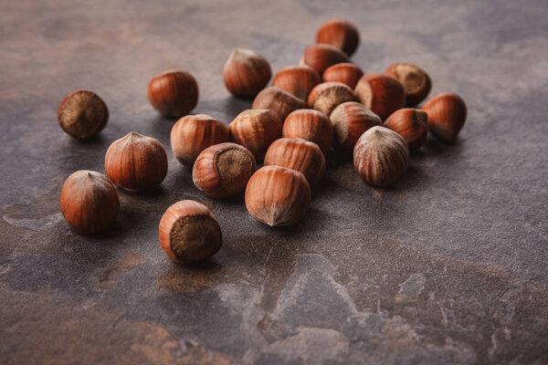 close up view of shelled hazelnuts on grey tabletop