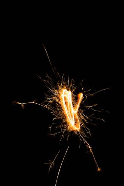 close-up view of festive burning christmas sparkler on black background   clipart