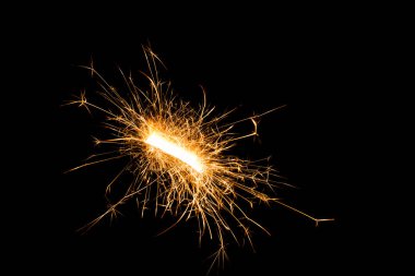 close-up view of festive christmas sparkler on black background   clipart