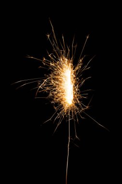 bright glowing new year sparkler on black background   clipart