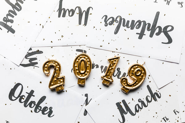 close-up view of golden 2019 candles and calendar