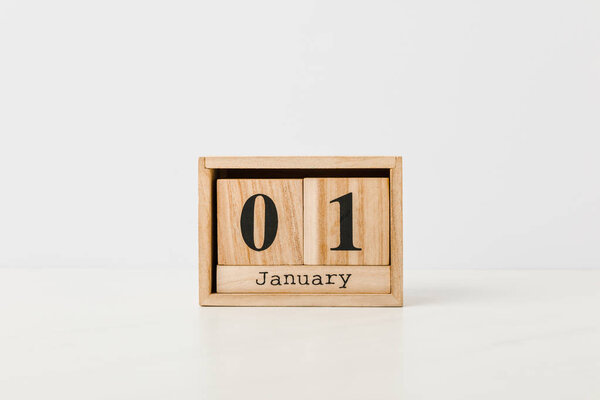 close-up view of wooden calendar with 01 january on white background