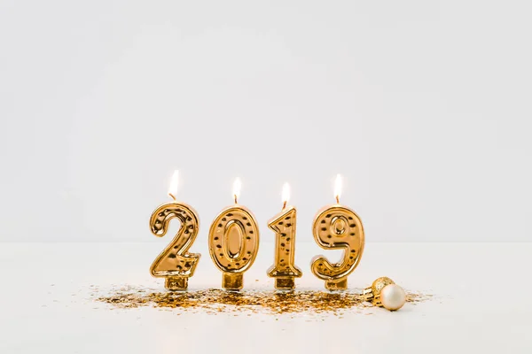 Close View Burning 2019 Candles Golden Confetti White Background — Stock Photo, Image