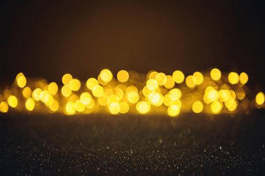 selective focus of blurred sparkling lights and bokeh on black clipart