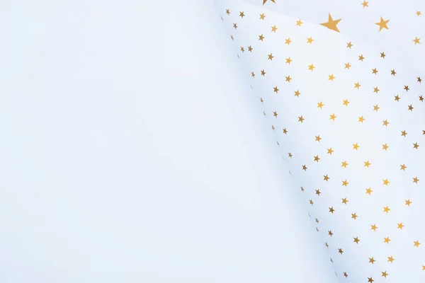top view of festive paper decorated by golden stars isolated on white 