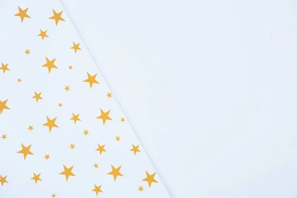 elevated view of festive paper decorated by golden stars isolated on white 