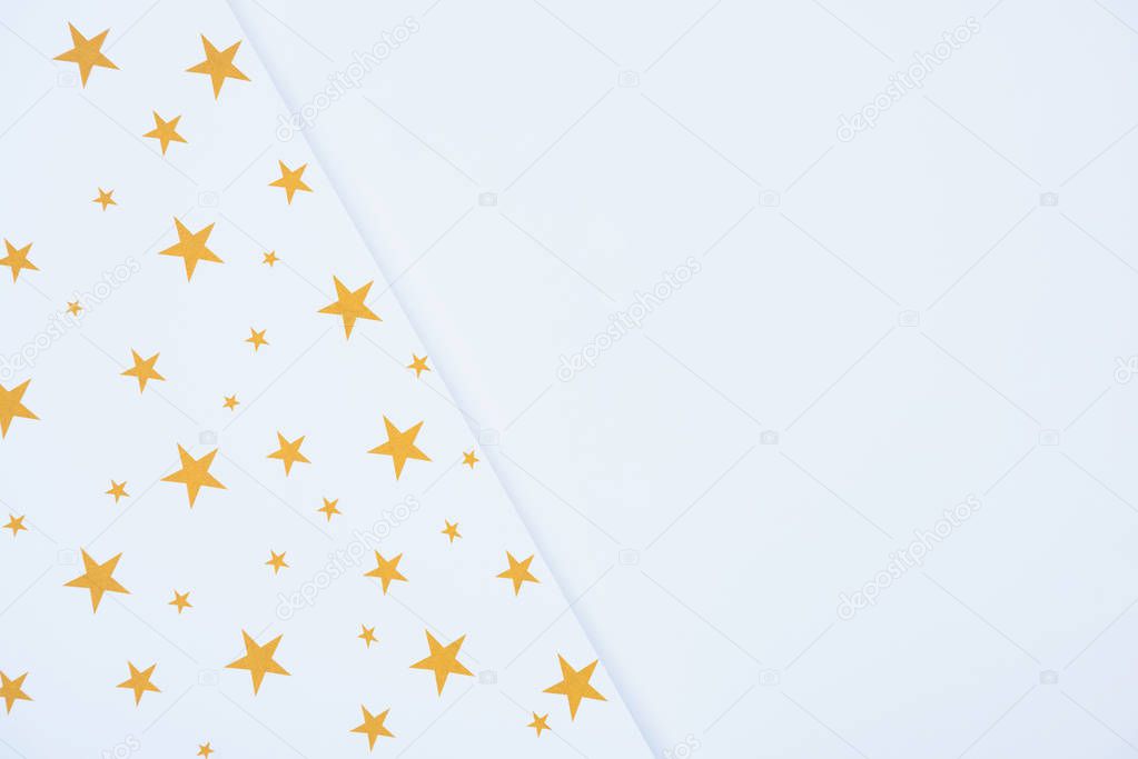 elevated view of festive paper decorated by golden stars isolated on white 