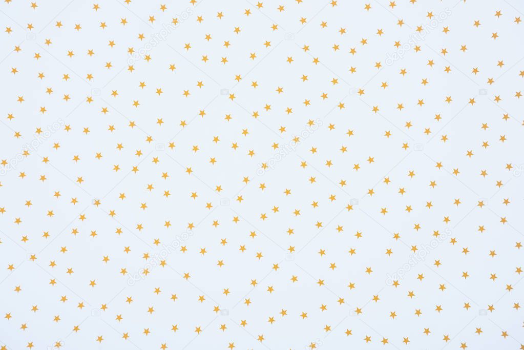 full frame image of festive paper decorated by golden stars background