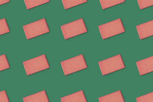 緑の背景に分離された赤のラップされたギフトのトップ ビュー — ストック写真