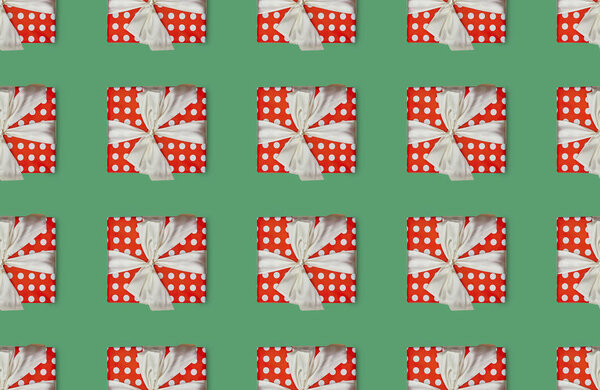 christmas seamless background with gift boxes with polka dots and bows