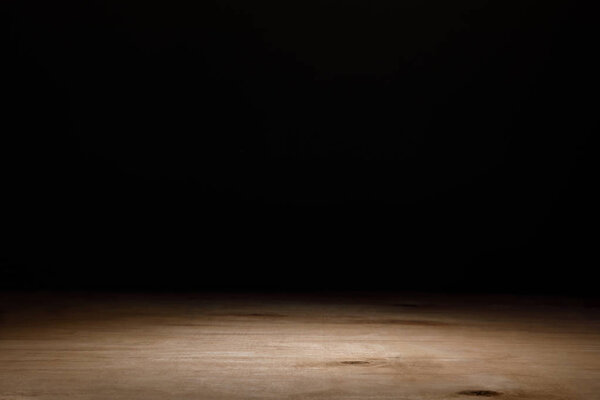 brown wooden textured table on black