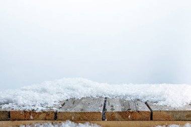 striped wooden fence covered with snow on white clipart