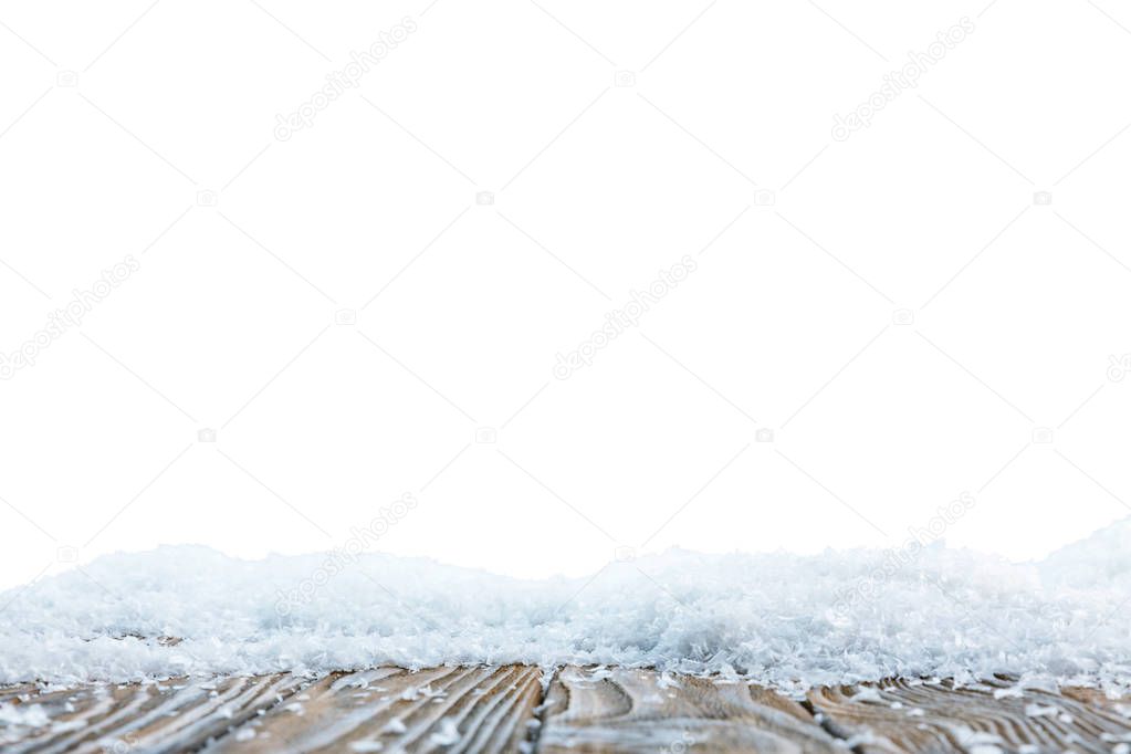 brown wooden board covered with snow on white