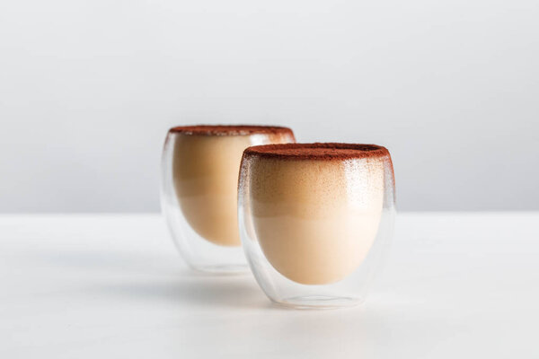 two tiramisu desserts with cocoa powder