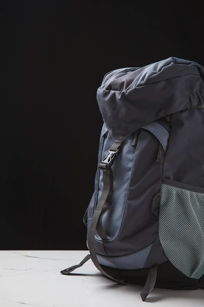 close-up view of backpack for hiking on black background, travel concept