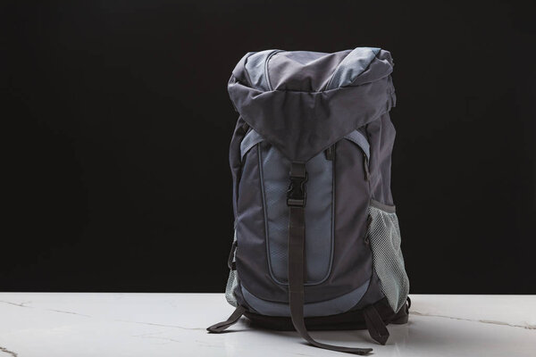 backpack for hiking on black background, travel concept  