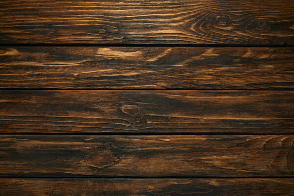 top view of dark brown wooden background with horizontal planks