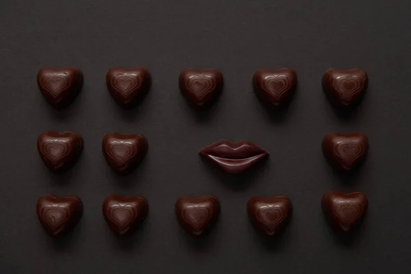 Top View Tasty Chocolate Lips Chocolate Hearts Black Background — Stock Photo, Image