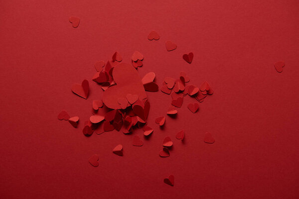 top view of decorative paper cut hearts on red background