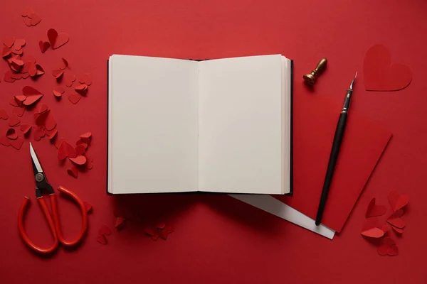 Top View Paper Cut Hearts Scissors Empty Notebook Red Background — Stock Photo, Image