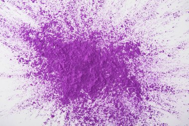 top view of explosion of purple holi powder on white background clipart