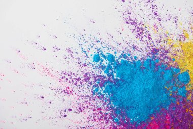 top view of explosion of yellow, purple and blue holi powder on white background clipart