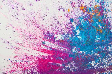 top view of explosion of purple and blue holi powder on white background clipart