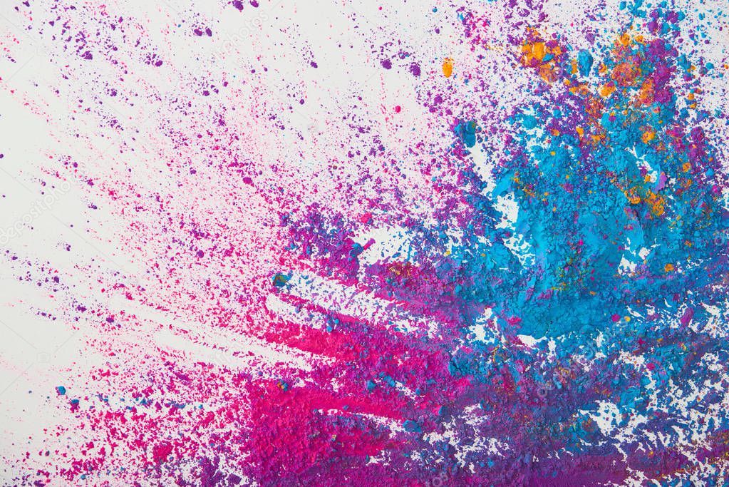 top view of explosion of purple and blue holi powder on white background