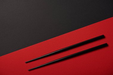 top view of chopsticks on red and black background with copy space clipart