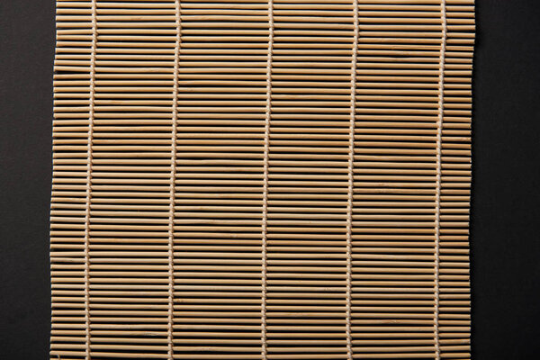 top view of bamboo table mat isolated on black