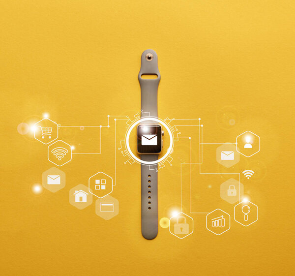 top view of smartwatch with system notification on yellow surface 