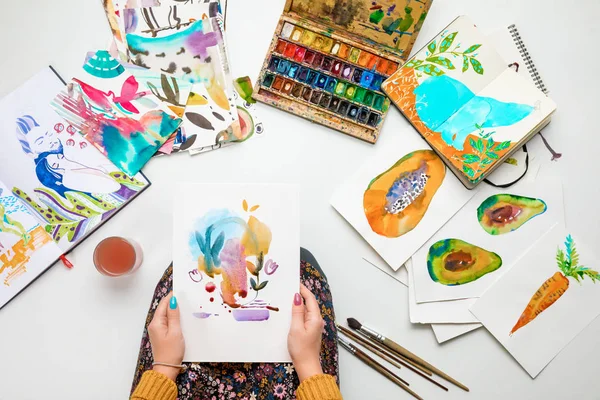 Top View Woman Holding Watercolor Drawing While Surrounded Color Pictures — Stock Photo, Image