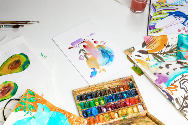 selective focus of colorful paints and watercolor drawings on white background