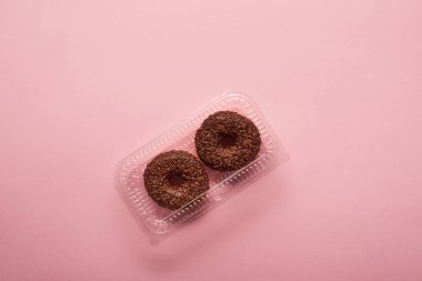 Çikolatalı donuts üstten görünüm pembe bir arka plan üzerinde 