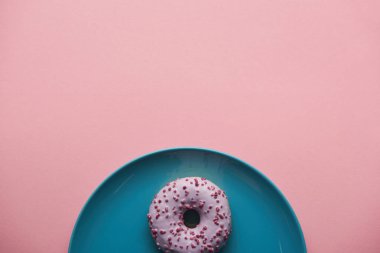 top view of sweet donut on blue plate isolated on pink  clipart
