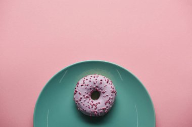 top view of glazed donut on blue plate isolated on pink  clipart