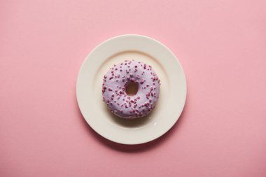 top view of tasty donut on white plate on pink background clipart