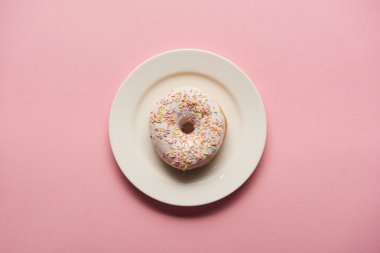 top view of delicious donut on white plate on pink background  clipart
