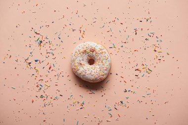 top view of tasty glazed doughnut on pink background