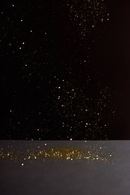 grey stone table with bright sparkles isolated on black 