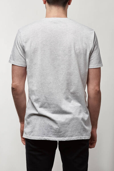 back view of man in casual white t-shirt with copy space isolated on grey