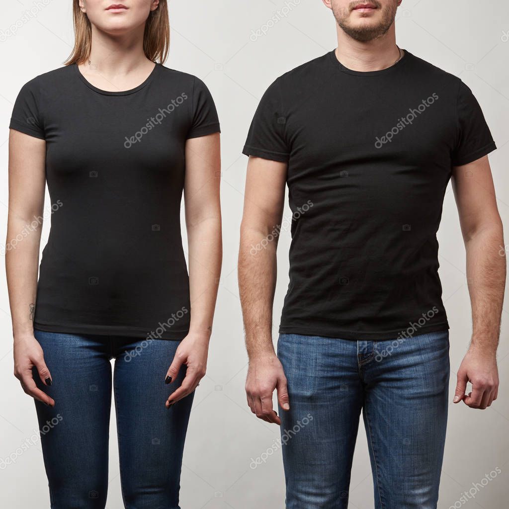 Cropped view of young man and woman in black t-shirts with copy space isolated on grey
