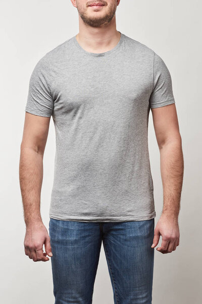 partial view of man in denim and t-shirt with copy space isolated on grey