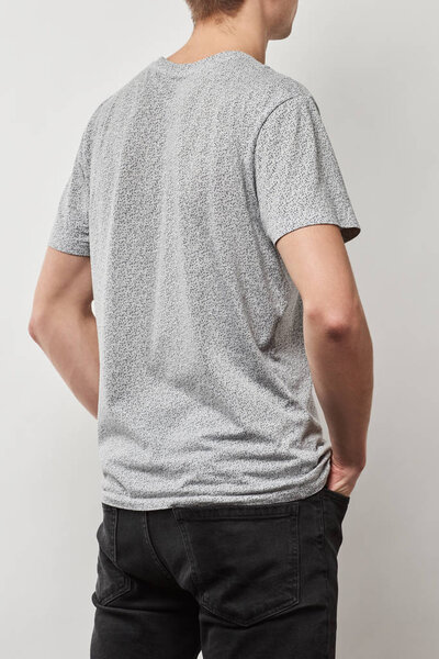 back view of man in t-shirt with copy space isolated on grey